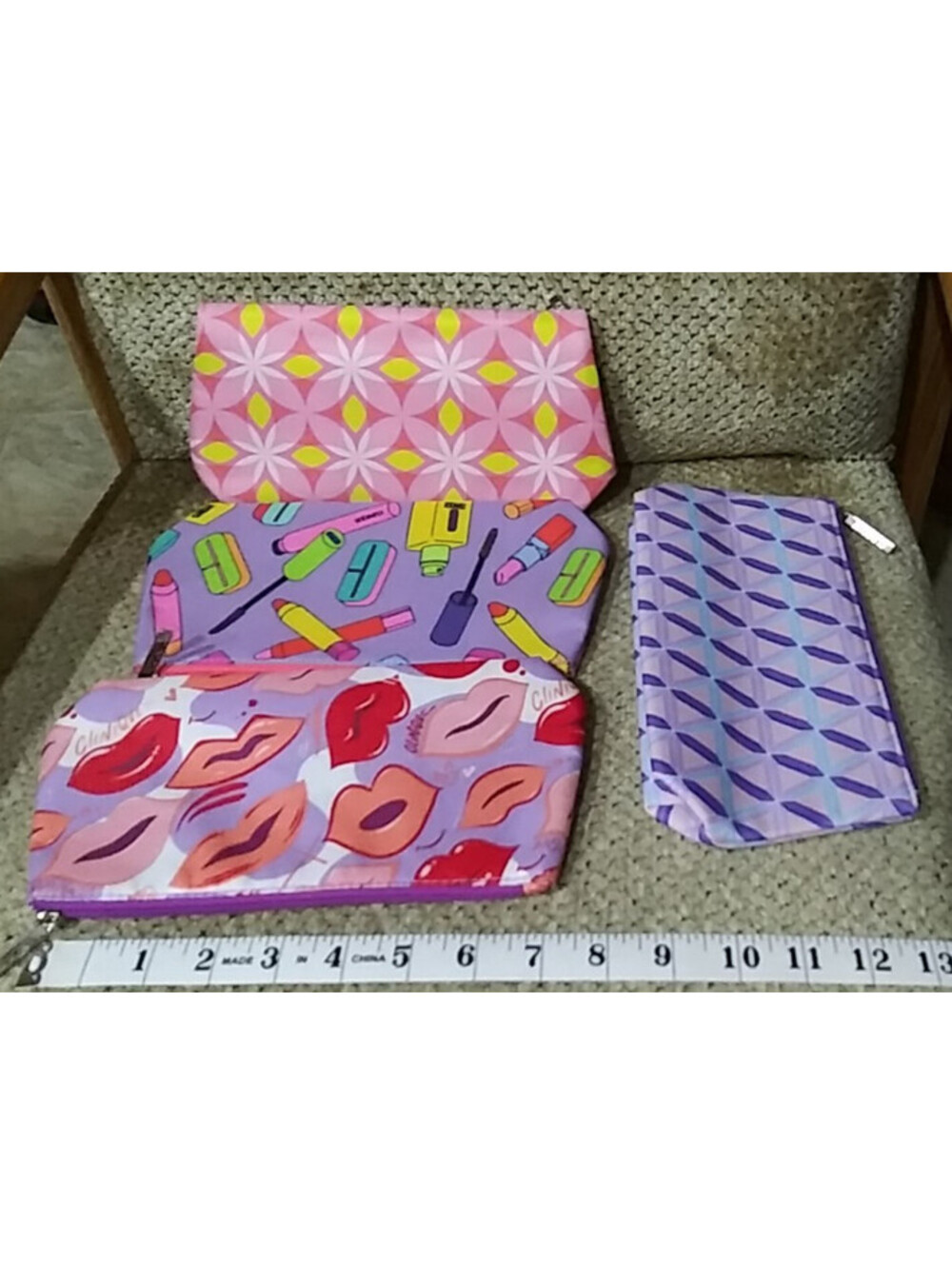 Clinique 4-Piece Women's Cosmetic Bags Set with Various Pastel Prints